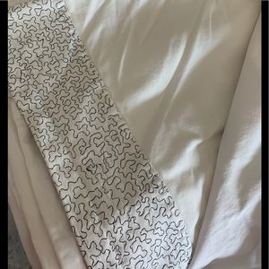 Queen size flat sheet with embroidered detailing.